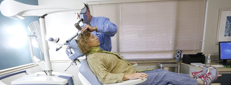 Patient sits in the chair of the NeuroStar